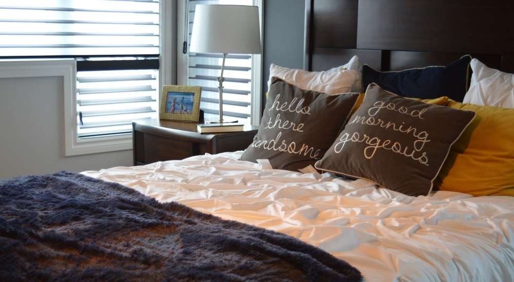 Bedrom with large window and side lamp at Cross Timbers At Grand Street in Amarillo, Texas
