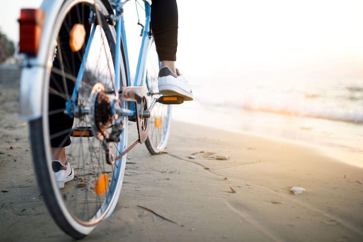 Residents biking on the beach near Marina Harbor in Marina del Rey, California