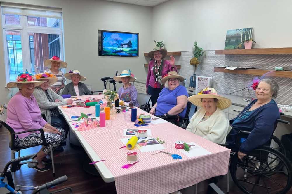 A group of women in hats sitting at a table at The Barclay at Charlottesville in Charlottesville, Virginia.