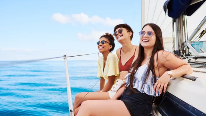 three friends smiling while on a boat | boat tours in Jacksonville