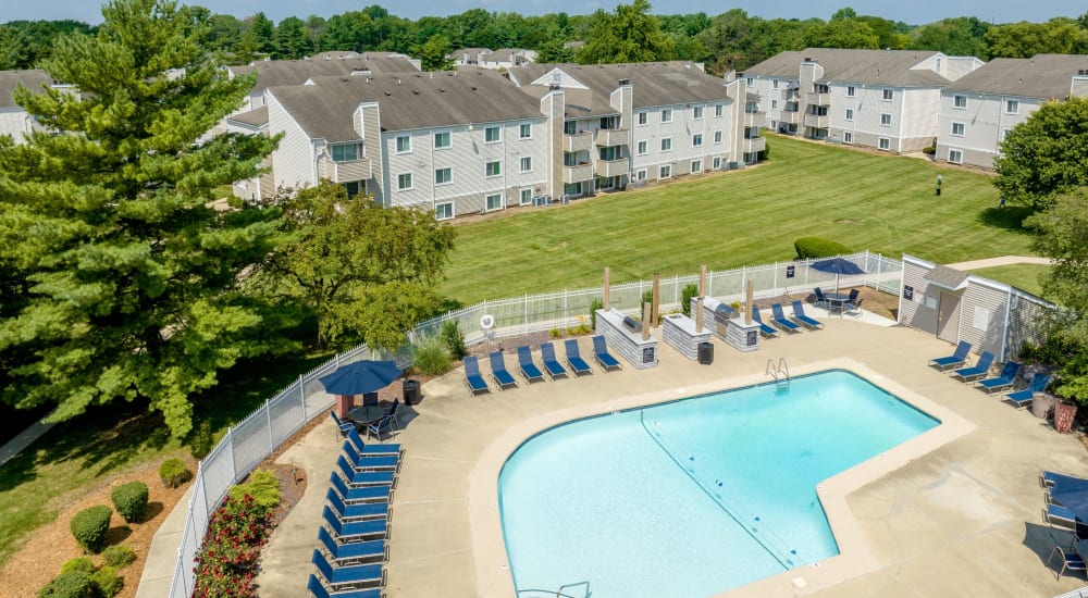 Sparkling pool and seating at The Candles Apartments in Springfield, Illinois