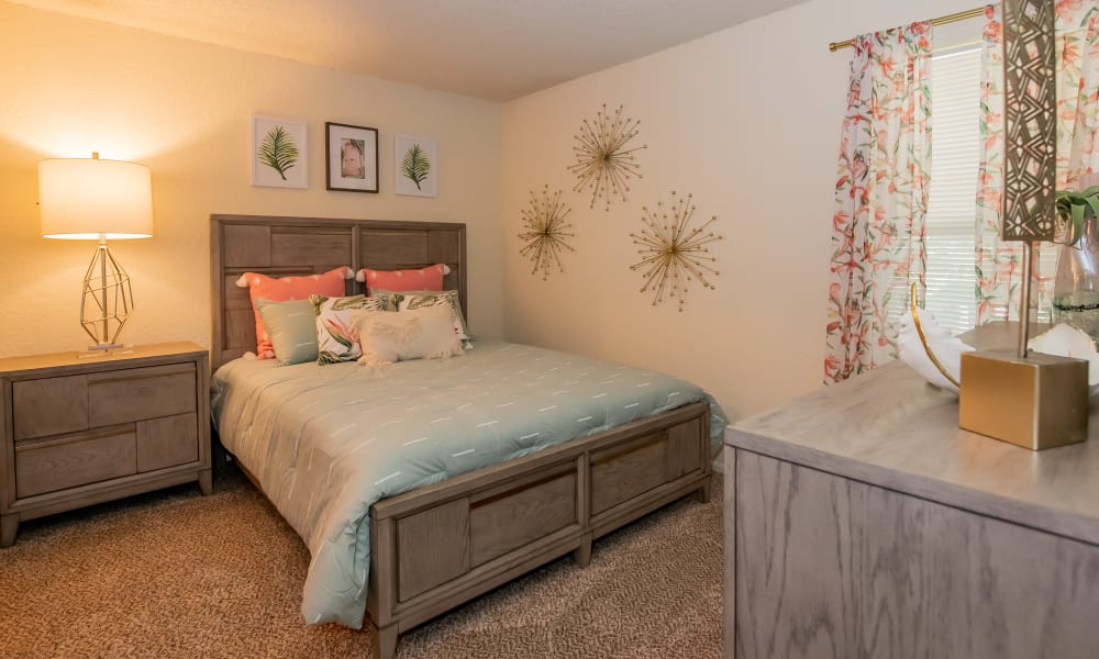 Bedroom with a large window at Aspen Park Apartments in Wichita, Kansas