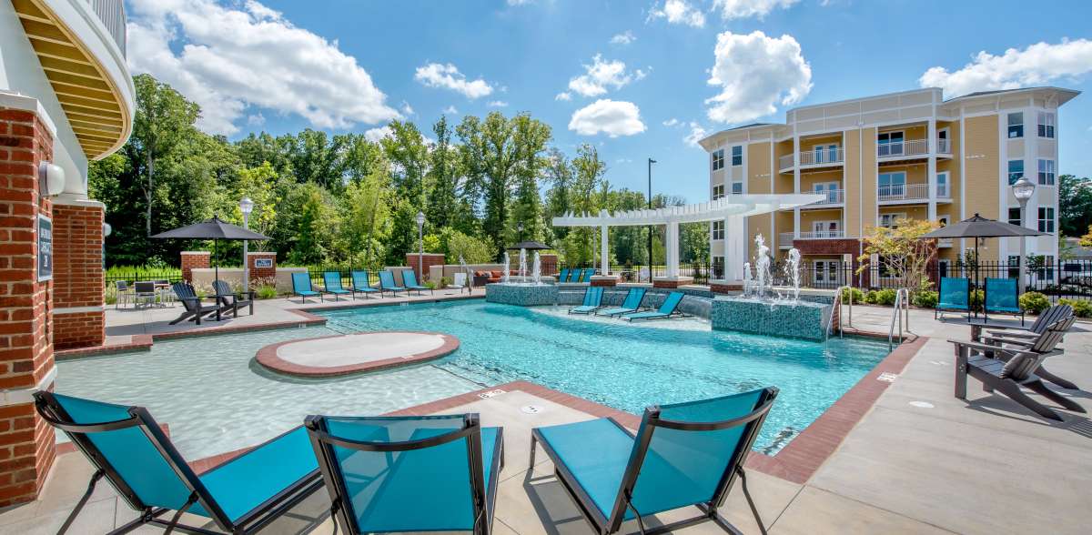 Resort-style pool with lounge chairs at Attain at Quarterpath, Williamsburg, Virginia