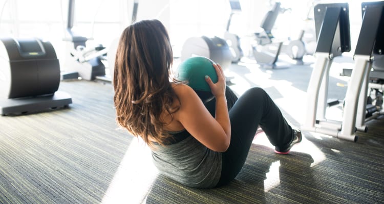 Resident getting in shape in the fitness center at Arista at Ocotillo in Chandler, Arizona