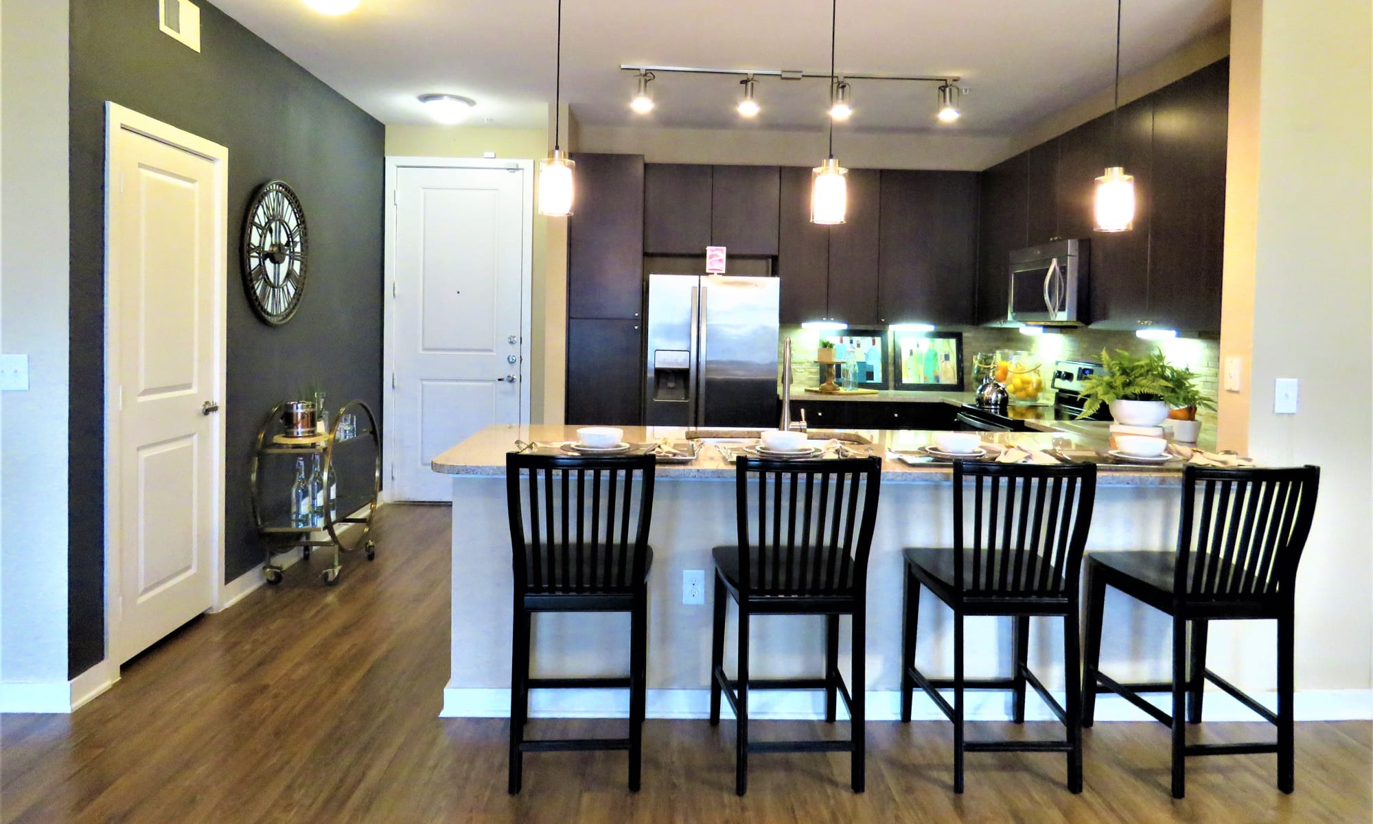 View of model apartment home's kitchen from the breakfast bar at The Abbey at Spring Town Center