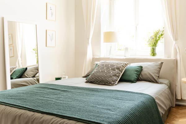 Model bedroom with plenty of natural light in an apartment home at Kingsbury Plaza in Columbus, Ohio