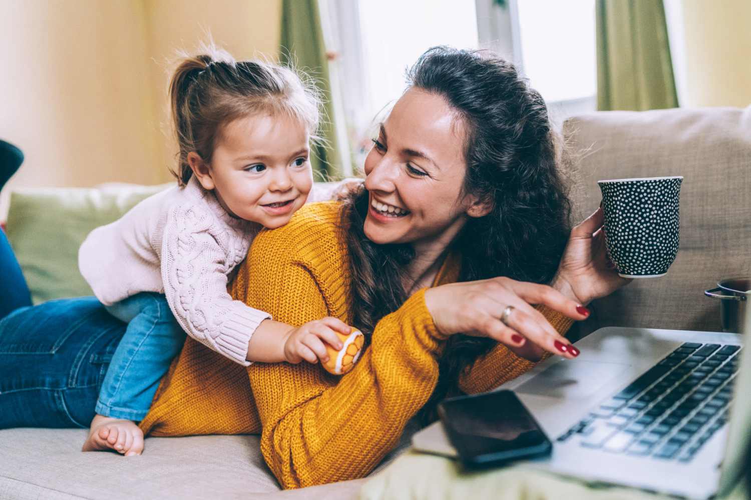 Woman with her daughter in living room at Mcnair Manor Apartments in Batesville, Indiana