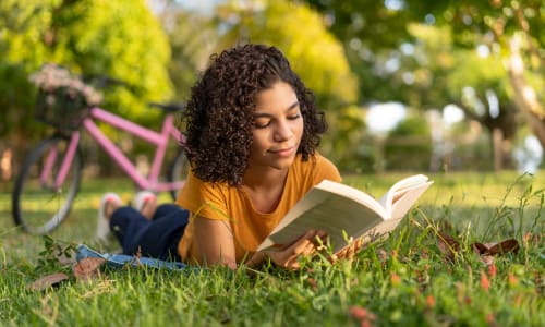 Reading in the grass at Sequoyah Apartments in Concord, California