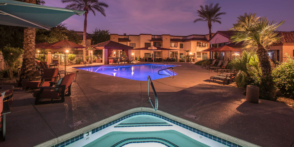 Swimming pool and spa at night at Scottsdale Highlands Apartments in Scottsdale, Arizona