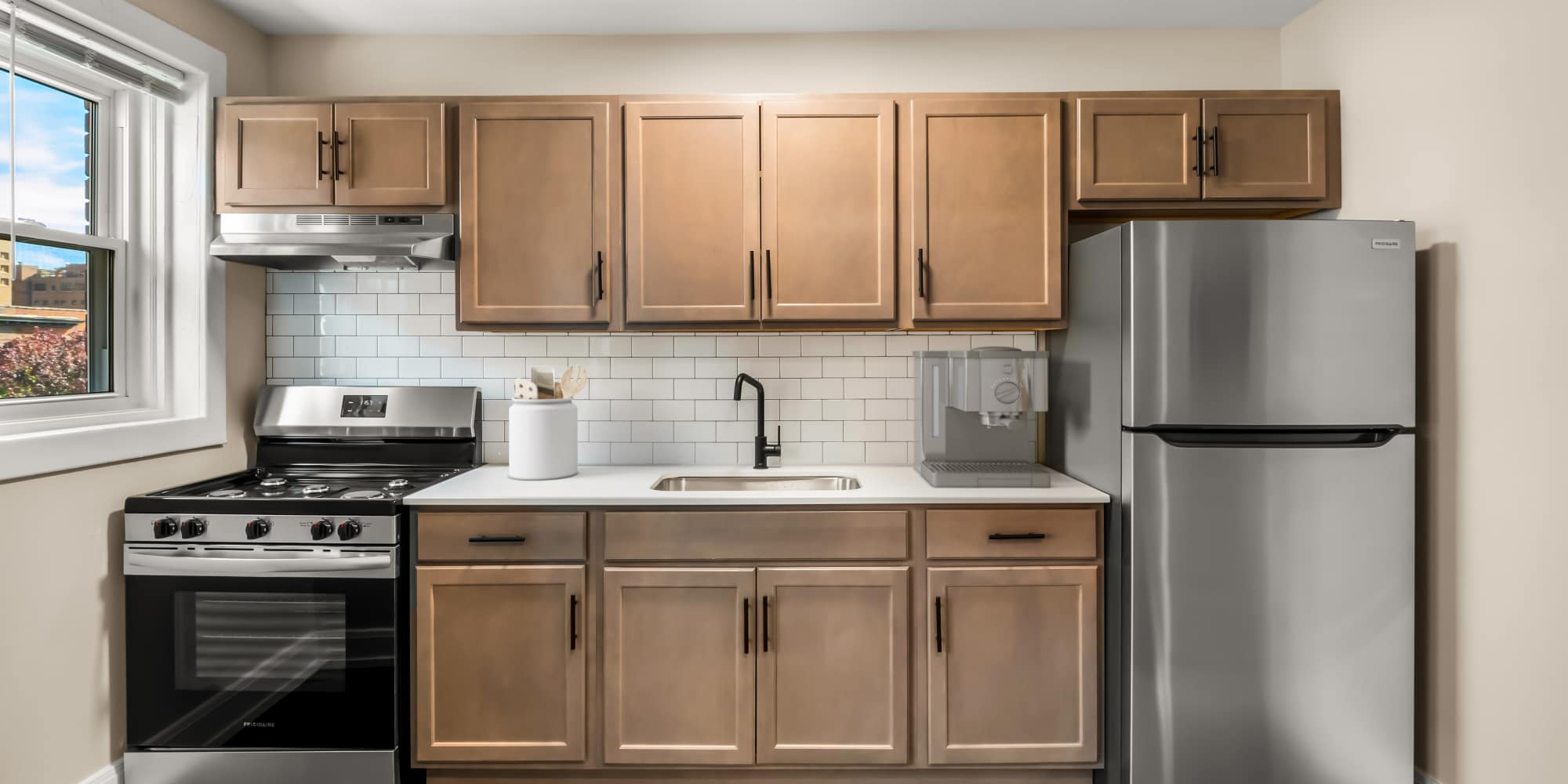 Kitchen with appliances and cabinets at Detroit Living in Detroit, Michigan