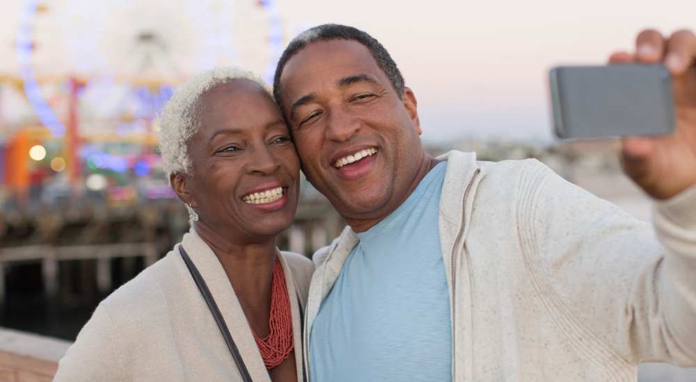 Senior couple taking selfie near Village Center in Detroit, Michigan
