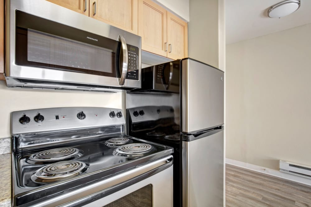 Plenty of cupboard storage and stainless-steel appliances in a model apartment's kitchen at Vantage Park Apartments in Seattle, Washington