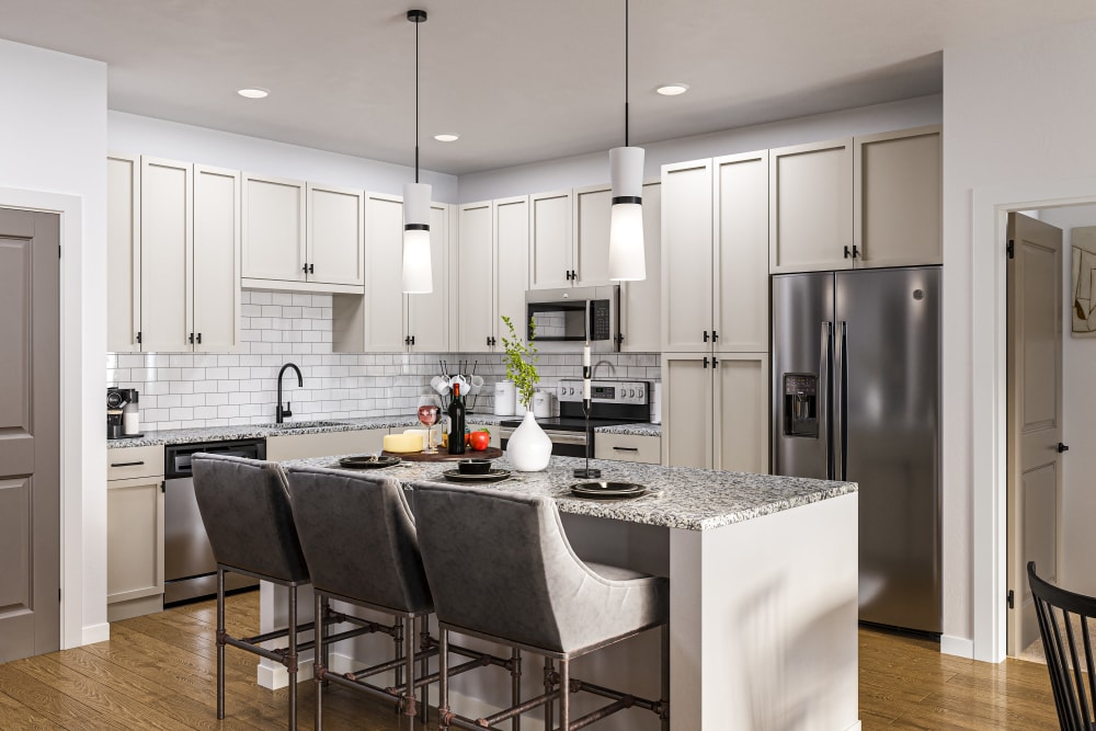 Luxury Apartments for Rent in Belville, NC - Westport Lofts - Gourmet Kitchen with Wood-Inspired Flooring, Kitchen Island, Granite Countertops, Designer Lighting, Beige Cabinets, and Stainless Steel Appliances
