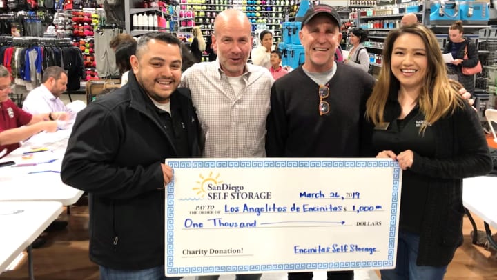 Encinitas Self Storage presenting donation to Los Angelitos de Encinitas