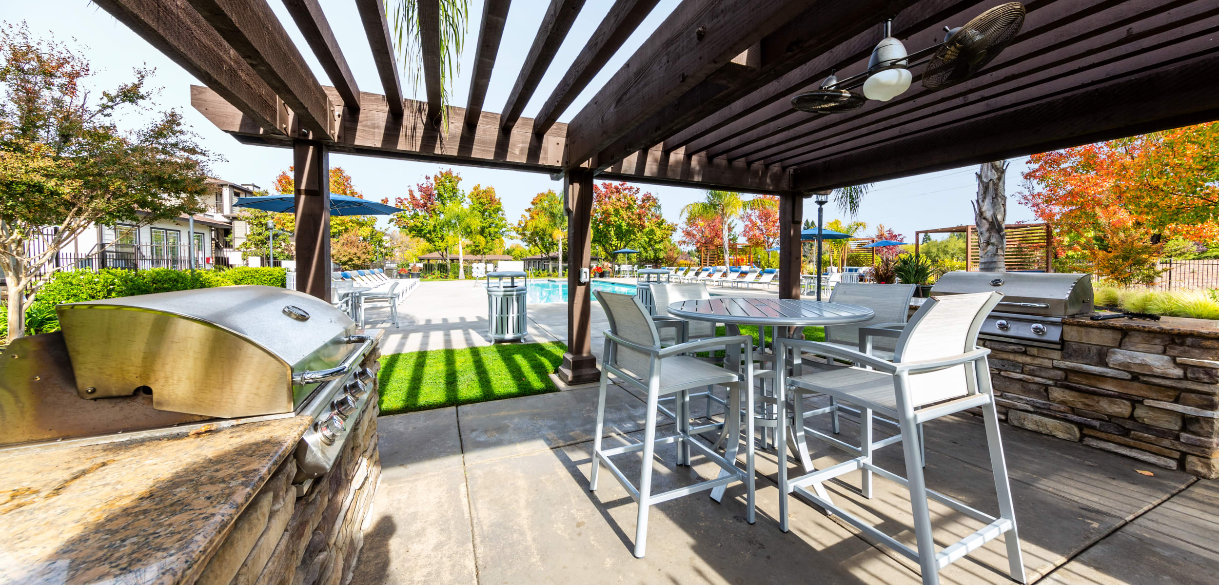 Outdoor covered poolside BBQ and dining area at The Fairmont at Willow Creek in Folsom, California