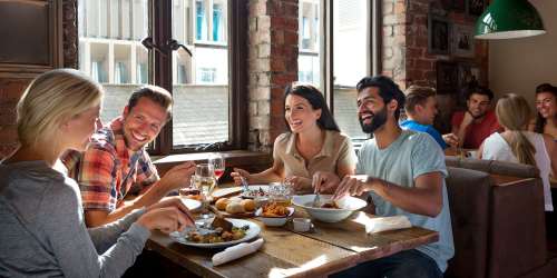 Group of residents enjoying their meal at a restaurant near Douglas Park in Compton, California