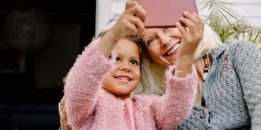 Resident taking a selfie with her granddaughter at a The Blake community