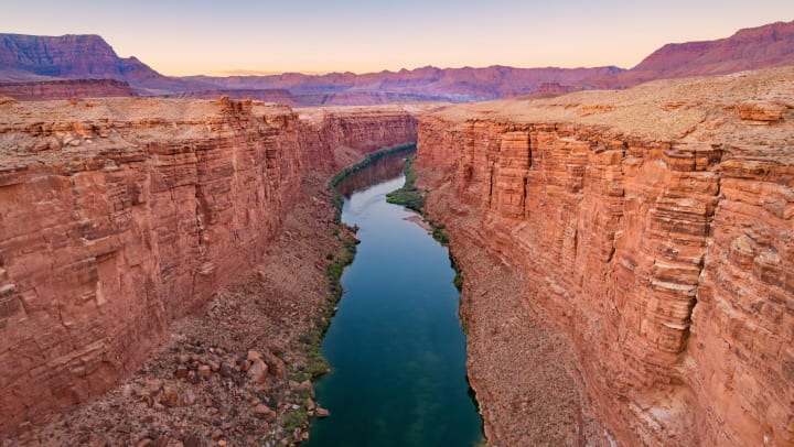 Photograph of the Marble Canyon and the Colorado River as seen from the Navajo Bridge in Arizona just after sunset.