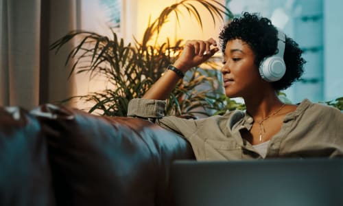 Woman listening to music in her home at City Walk Apartments in Concord, California