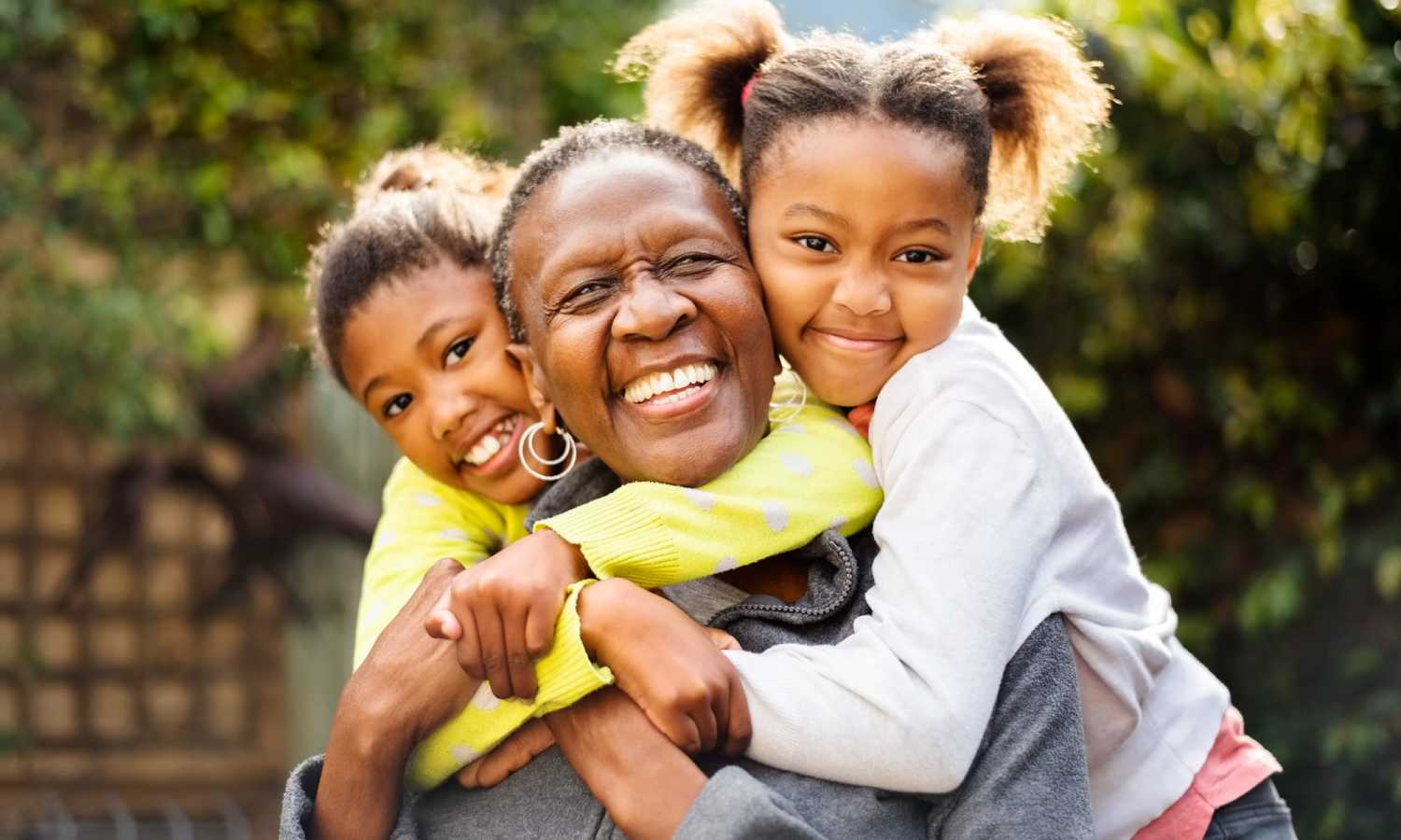 Smiling woman with two girls hugging at Ardmore & Twenty Eighth in Atlanta, Georgia