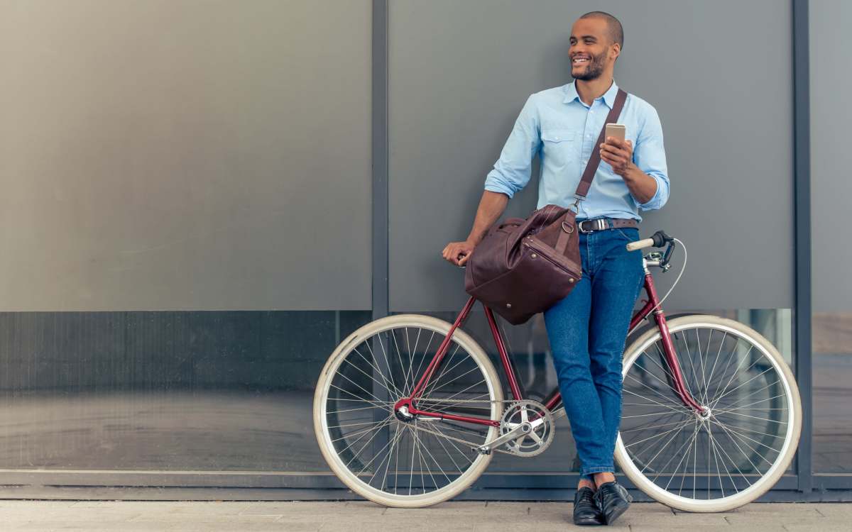 Resident leaning against a building with his bike near Bernwood Trace in Fort Myers, Florida