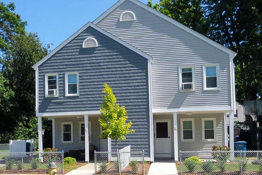 Building exterior with landscaped entrance at E. Henry Twiggs Estates Phase I in Springfield, Massachusetts