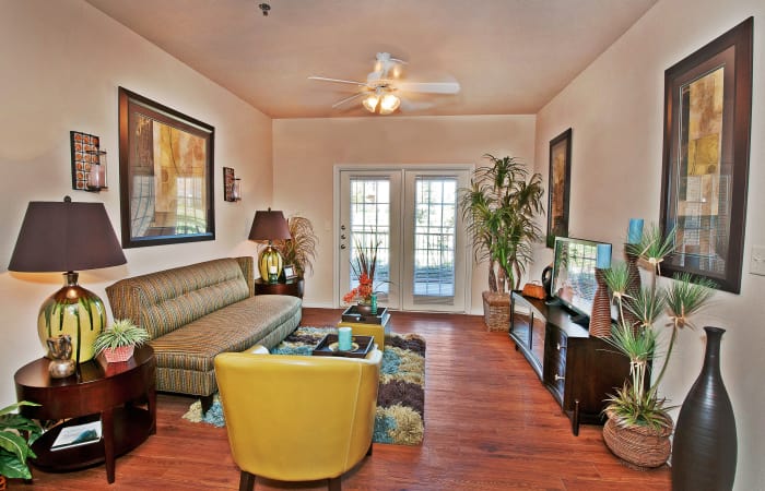 Hardwood floors and ceiling fan in model home's living room at Trails at Buda Ranch in Buda, Texas