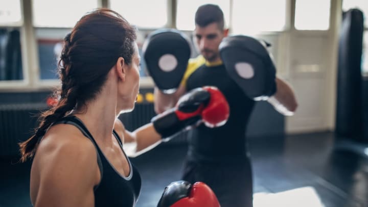 Woman training with an instructor during a martial arts class | martial arts studios in Spring