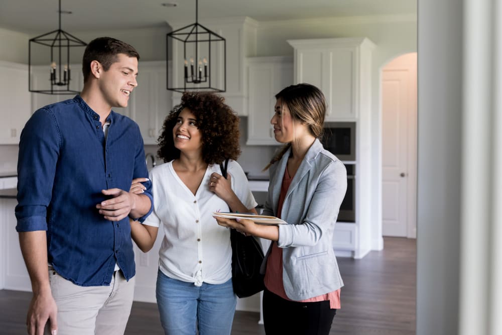 Couple talking to a property manager about a home with Morgan Properties in King of Prussia, Pennsylvania