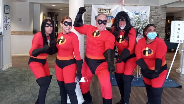 Employees at Gentry Park wearing Mr. Incredible Costumes