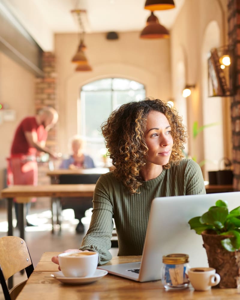 Resident working from a coffee shop at Creekside Park Apartments in Napa, California