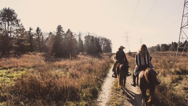 Residents enjoying a horseback ride on a trail near Olympus Stone Glen in Keller, Texas. 