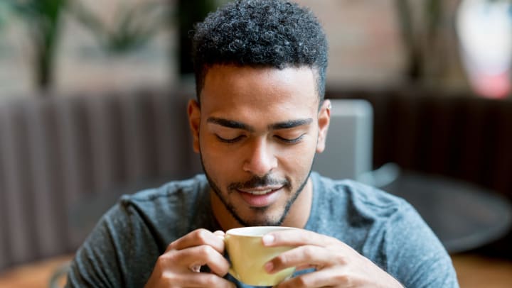 Man drinking coffee at a local shop