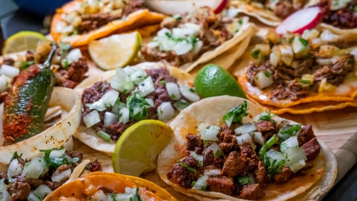 Assortment of tacos with lime wedges