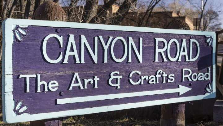 Purple sign that says "The Art & Craft Road"
