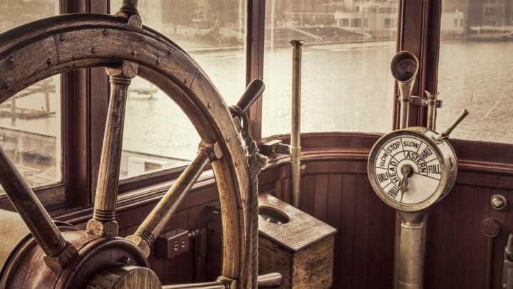 A vintage ship steering wheel displayed in a museum | Ships of the Sea Maritime Museum 
