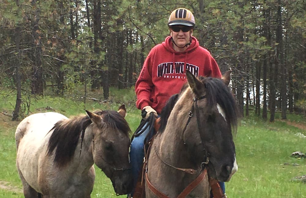 Jeffrey Bair from Touchmark Central Office in Beaverton, Oregon riding a horse