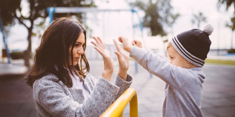 a mom and son playing at a school near Howard Gilmore Terrace in La Mesa, California