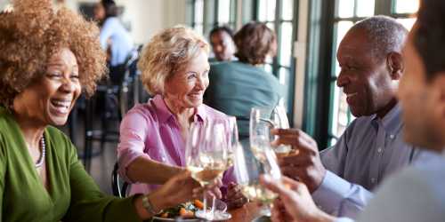 Residents toasting glasses at The Veranda at North Main in Columbia, South Carolina