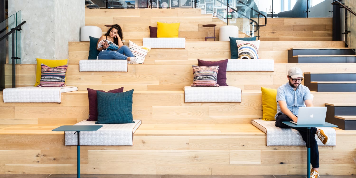 People working and sitting on steps at Paradigm Companies