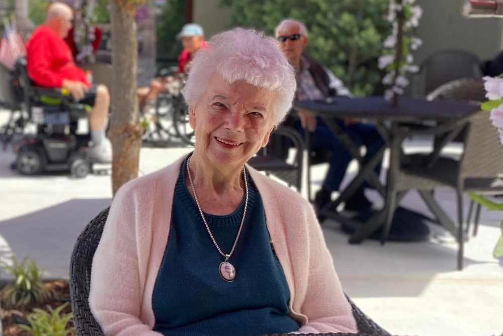 Resident in courtyard at community Ray Stone Inc. in Sacramento, California