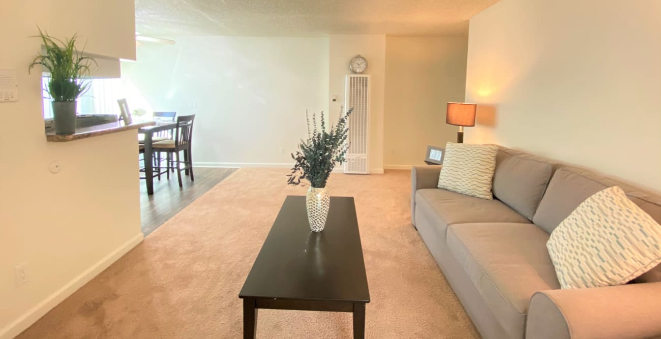 Spacious living room in a studio apartment with an open concept dining and kitchen at The Windsor in Sherman Oaks, California