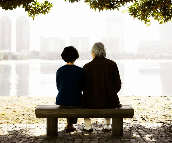 Couple sitting on bench at Majestic Memory Care,Hollywood, FL