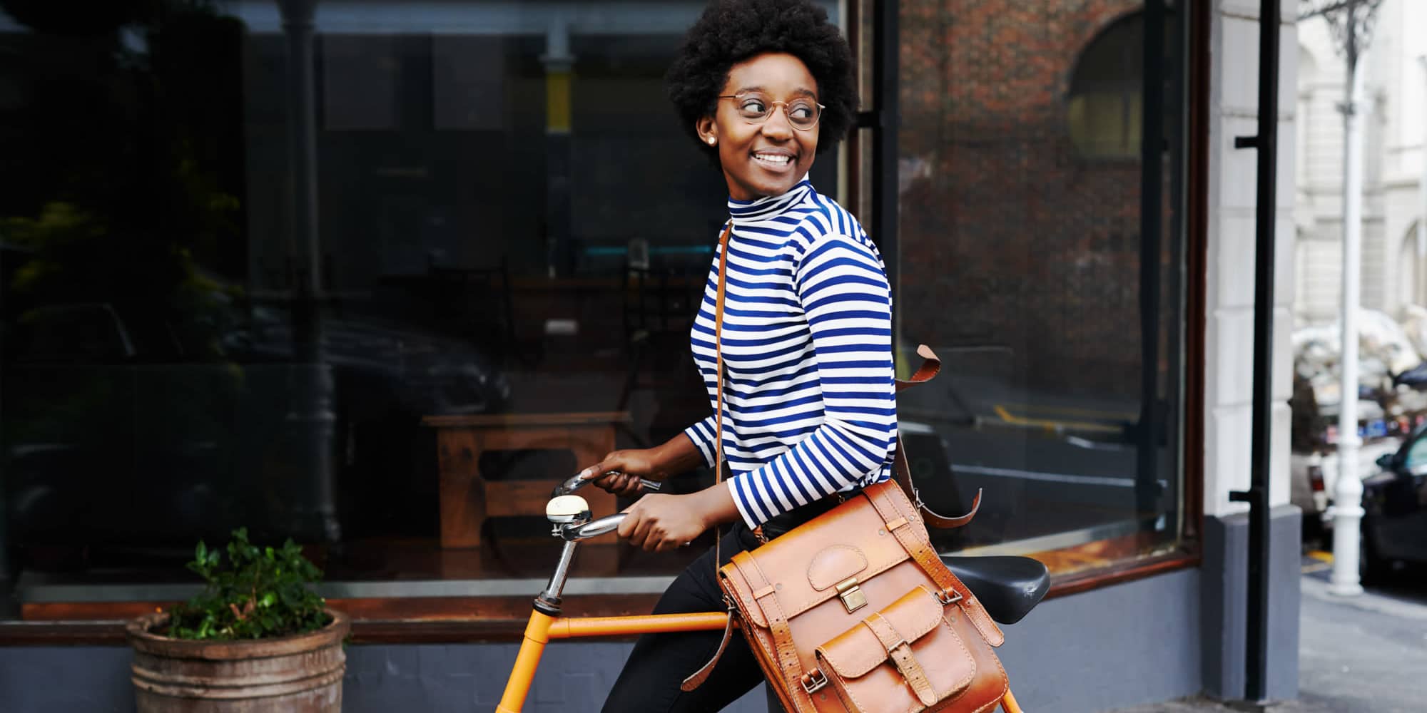 Resident walking with her bike to work near The Garnett in Brooklyn, New York