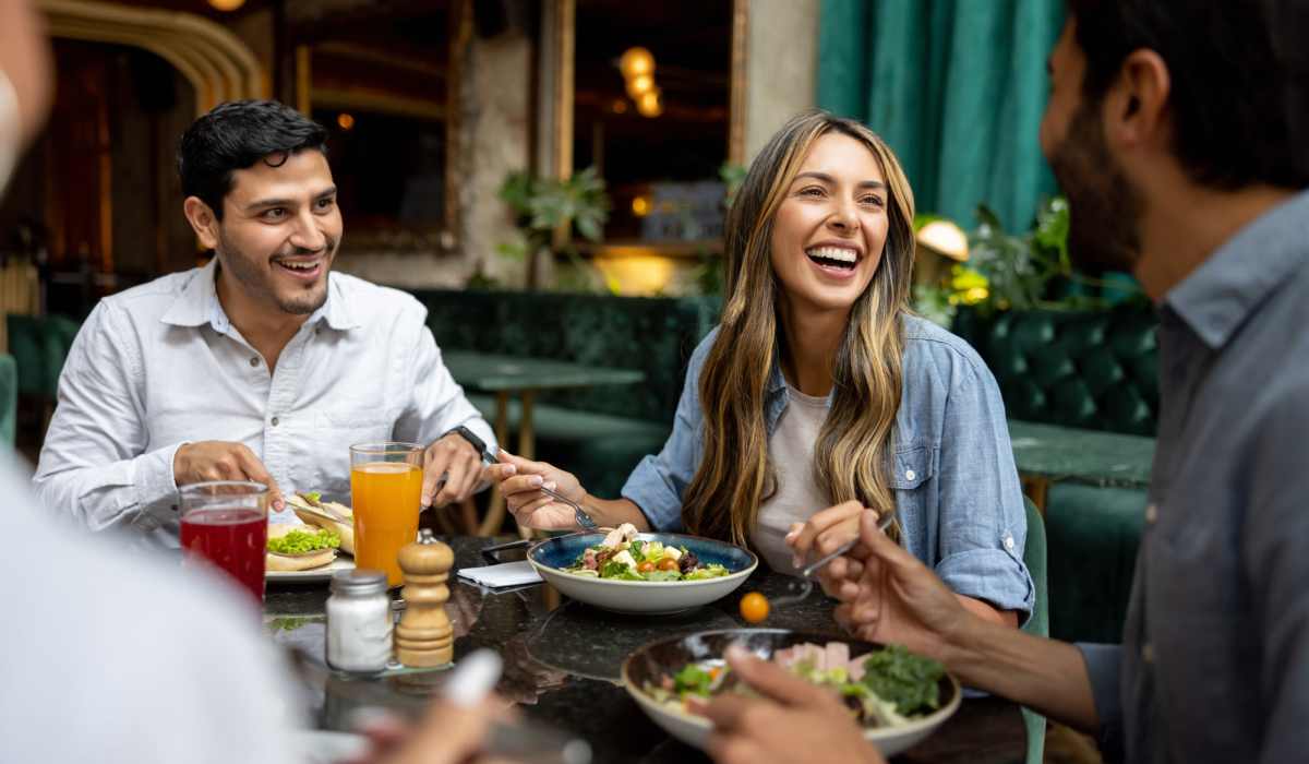 Friends having food near Warwick at Westchase in Houston, Texas