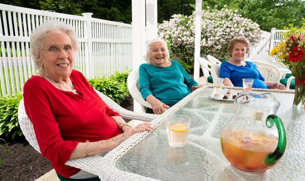 Residents enjoying the sunshine and flowers outside of Wheelock Terrace in Hanover, New Hampshire