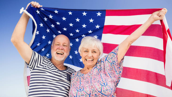 Smiling Couple holding United States Flag