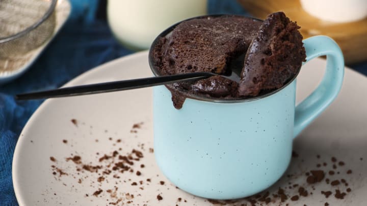 a mug brownie with a spoon 