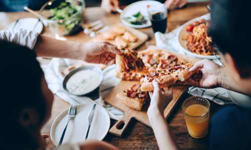 Couple having pizza in restaurant near Encore at West Valley in White Lake, Michigan