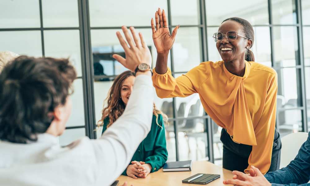 Team members high fiving at Emerald Properties in San Lorenzo, California